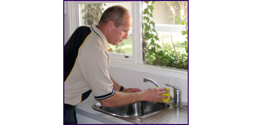 the final touches of a kitchen plumbing repair