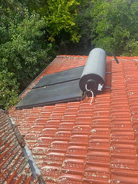 solar hot water systems can weigh up to 500kgs when full of water- The cracked roof tiles allowed water to leak into the roof when it rained